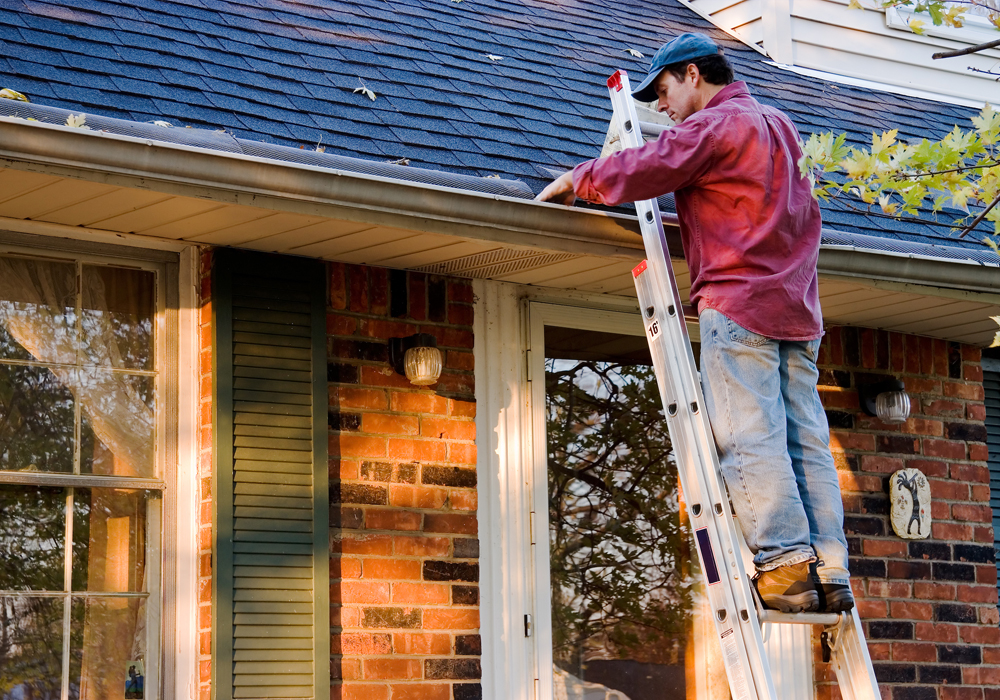 working cleaning house gutters