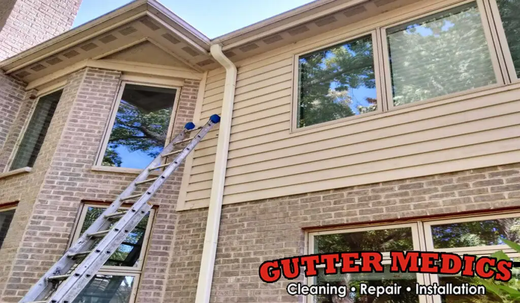 a two story house with gutters and downspout