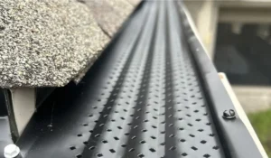Close-up of gutter guards installed under shingles to protect roofline and prevent debris-related overflow issues.