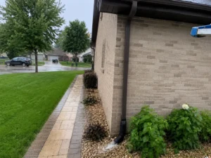 Clean Gutters During Heavy Rains directing runoff away from a home's foundation during a summer storm.