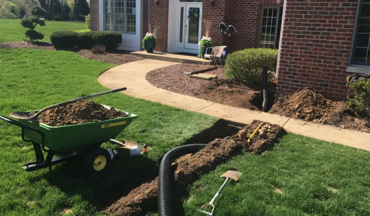 Underground Drainage Systems Home trenching project showing underground drainage system installation to protect foundation and improve lawn water flow.